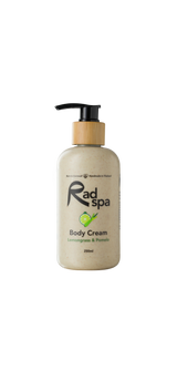 Body cream bottle with pump and wooden cap labeled 'Rad Spa' on a white background