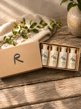 Set Rad Spa small bottles on a wooden surface with a box and plant.