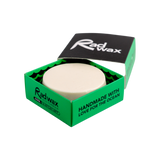 Green box containing a white bar of eco surf wax. Rad Wax Cool branding on a white background