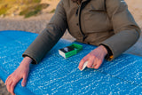 Surfer waxing a board with Rad Wax Cool Eco Surf Wax