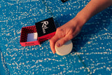 Surfer waxing a board with Rad Wax Tropical Top Coat