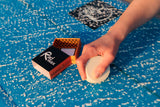 Surfer waxing a board with Rad Wax Warm Wax
