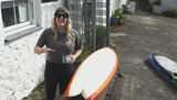 Surfer shows how to apply Rad Wax to surfboard